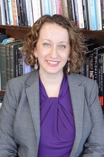 Stephanie Langin-Hooper in front of bookshelf
